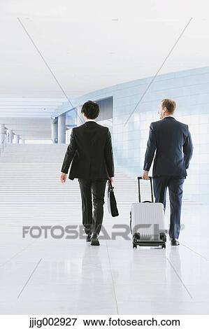 Stock Photo - Businessmen at the airport. Fotosearch