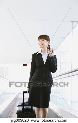 Stock Image - Businesswoman at the airport. Fotosearch