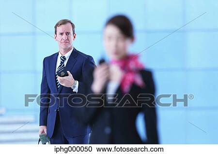 Stock Image - Caucasian businessman at the airport. Fotosearch