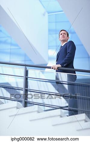 Stock Image - Caucasian businessman in modern office. Fotosearch