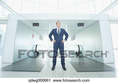 Caucasian businessman on escalator View Large Photo Image Stock Image - Caucasian businessman on escalator. Fotosearch