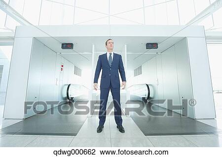 Caucasian businessman on escalator View Large Photo Image Stock Image - Caucasian businessman on escalator. Fotosearch