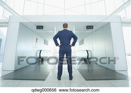 Caucasian businessman on escalator View Large Photo Image Stock Photograph - Caucasian businessman on escalator. Fotosearch