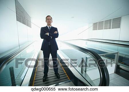Caucasian businessman on escalator View Large Photo Image Stock Photography - Caucasian businessman on escalator. Fotosearch