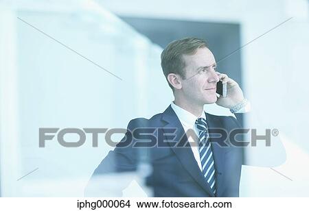 Picture - Caucasian businessman on the phone in modern office. Fotosearch