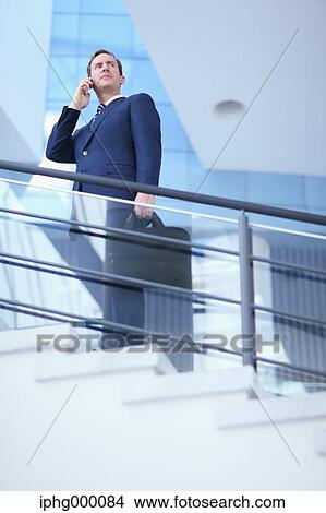 Caucasian businessman on the phone in modern office View Large Photo Image Picture - Caucasian businessman on the phone in modern office. Fotosearch