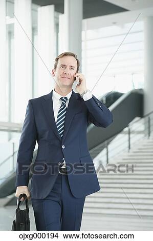 Picture - Caucasian businessman on the phone in modern office. Fotosearch
