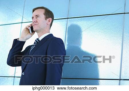 Caucasian businessman on the phone in modern office View Large Photo Image Stock Image - Caucasian businessman on the phone in modern office. Fotosearch