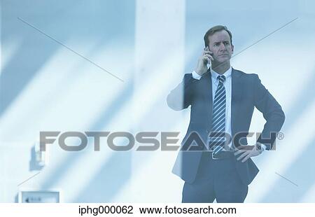 Caucasian businessman on the phone in modern office View Large Photo Image Stock Image - Caucasian businessman on the phone in modern office. Fotosearch