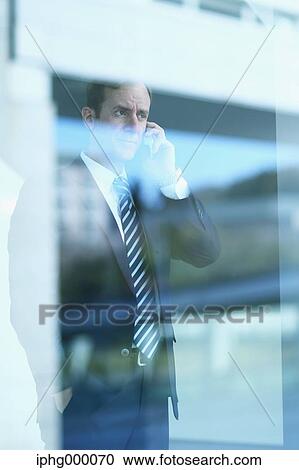 Caucasian businessman on the phone in modern office View Large Photo Image Stock Image - Caucasian businessman on the phone in modern office. Fotosearch