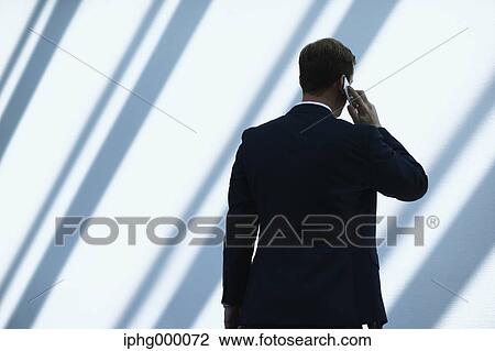 Caucasian businessman on the phone in modern office View Large Photo Image Stock Image - Caucasian businessman on the phone in modern office. Fotosearch