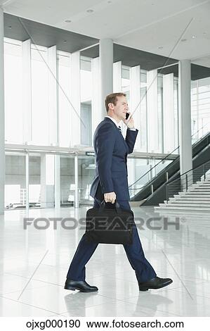 Caucasian businessman on the phone in modern office View Large Photo Image Stock Image - Caucasian businessman on the phone in modern office. Fotosearch
