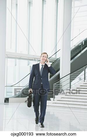Caucasian businessman on the phone in modern office View Large Photo Image Stock Image - Caucasian businessman on the phone in modern office. Fotosearch