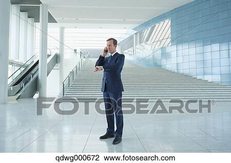 Caucasian businessman on the phone in modern office View Large Photo Image Stock Image - Caucasian businessman on the phone in modern office. Fotosearch