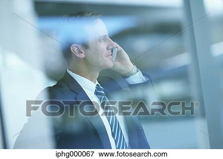 Caucasian businessman on the phone in modern office View Large Photo Image Stock Photo - Caucasian businessman on the phone in modern office. Fotosearch