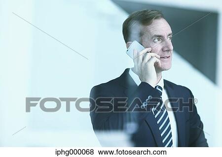 Caucasian businessman on the phone in modern office View Large Photo Image Stock Photo - Caucasian businessman on the phone in modern office. Fotosearch