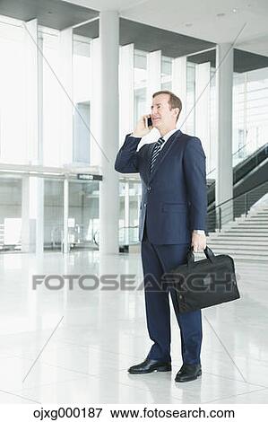 Caucasian businessman on the phone in modern office View Large Photo Image Stock Photo - Caucasian businessman on the phone in modern office. Fotosearch