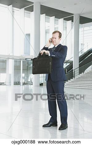 Caucasian businessman on the phone in modern office View Large Photo Image Stock Photo - Caucasian businessman on the phone in modern office. Fotosearch