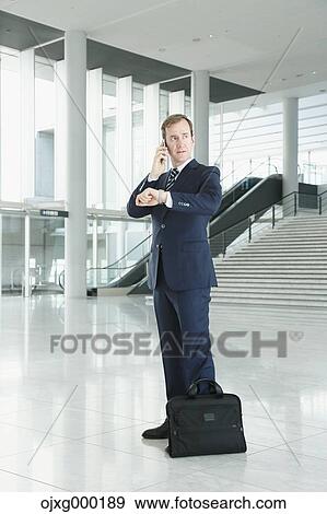 Caucasian businessman on the phone in modern office View Large Photo Image Stock Photo - Caucasian businessman on the phone in modern office. Fotosearch