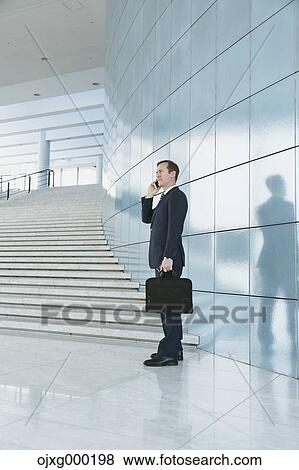 Caucasian businessman on the phone in modern office View Large Photo Image Stock Photo - Caucasian businessman on the phone in modern office. Fotosearch