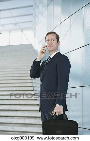 Caucasian businessman on the phone in modern office View Large Photo Image Stock Photo - Caucasian businessman on the phone in modern office. Fotosearch