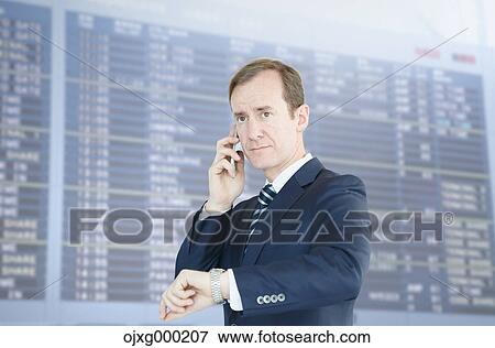 Stock Photo - Caucasian businessman on the phone in modern office. Fotosearch