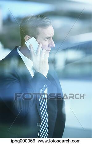 Caucasian businessman on the phone in modern office View Large Photo Image Stock Photograph - Caucasian businessman on the phone in modern office. Fotosearch