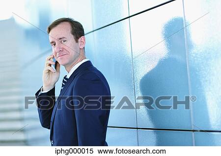 Caucasian businessman on the phone in modern office View Large Photo Image Stock Photography - Caucasian businessman on the phone in modern office. Fotosearch