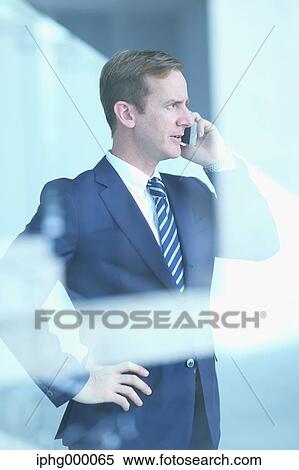Caucasian businessman on the phone in modern office View Large Photo Image Stock Photography - Caucasian businessman on the phone in modern office. Fotosearch
