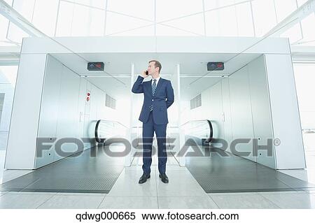 Stock Photography - Caucasian businessman on the phone in modern office. Fotosearch