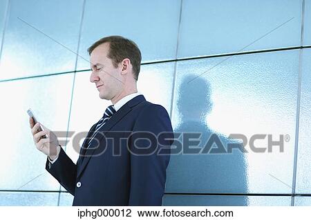Caucasian businessman with phone in modern office View Large Photo Image Stock Image - Caucasian businessman with phone in modern office. Fotosearch