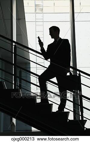 Caucasian businessman with phone in modern office View Large Photo Image Stock Image - Caucasian businessman with phone in modern office. Fotosearch