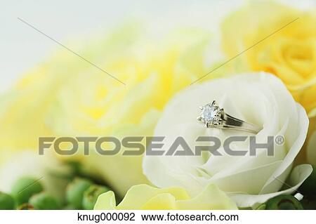 Stock Image - Flower bouquet and diamond ring. Fotosearch