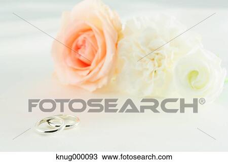 Stock Image - Flower bouquet and wedding rings. Fotosearch