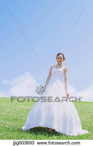 Stock Image - Japanese attractive bride in a city park. Fotosearch
