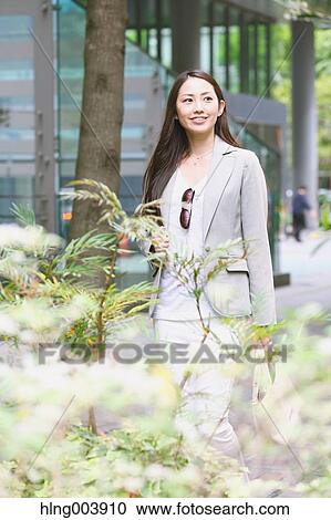 Stock Image - Japanese attractive businesswoman in downtown Tokyo. Fotosearch