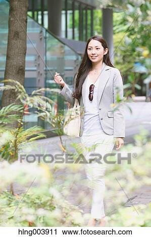 Stock Image - Japanese attractive businesswoman in downtown Tokyo. Fotosearch