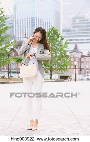 Stock Image - Japanese attractive businesswoman in downtown Tokyo. Fotosearch