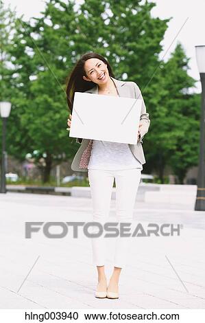 Stock Image - Japanese attractive businesswoman in downtown Tokyo. Fotosearch