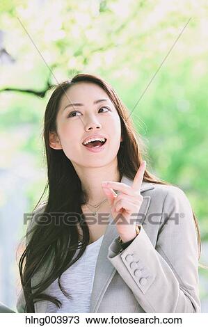 Stock Image - Japanese attractive businesswoman in downtown Tokyo. Fotosearch