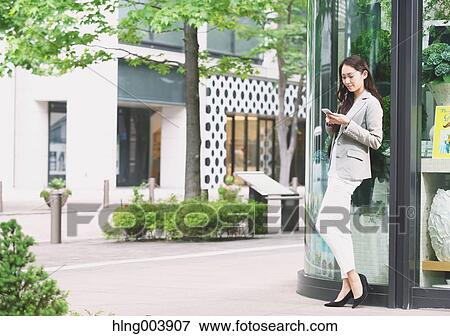 Stock Photo - Japanese attractive businesswoman in downtown Tokyo. Fotosearch