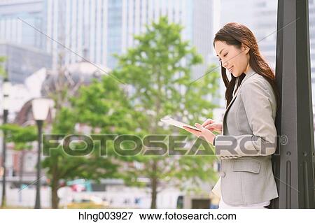 Stock Photo - Japanese attractive businesswoman in downtown Tokyo. Fotosearch