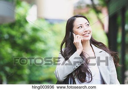 Stock Photograph - Japanese attractive businesswoman in downtown Tokyo. Fotosearch