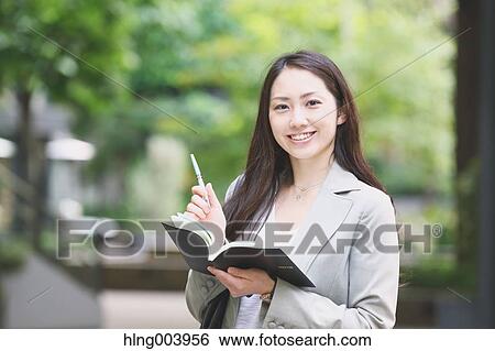Stock Photograph - Japanese attractive businesswoman in downtown Tokyo. Fotosearch
