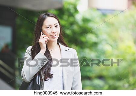 Stock Photography - Japanese attractive businesswoman in downtown Tokyo. Fotosearch