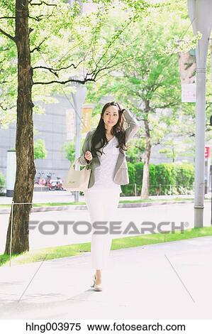Stock Photography - Japanese attractive businesswoman in downtown Tokyo. Fotosearch