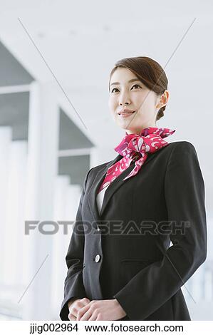 Picture - Japanese attractive flight attendant at the airport. Fotosearch