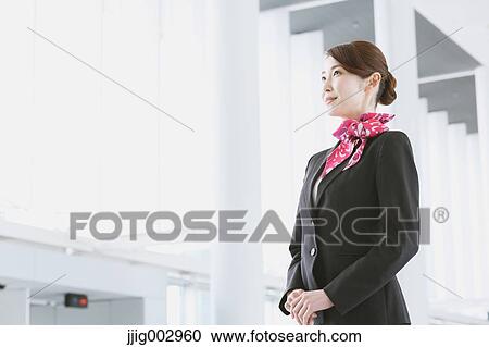 Stock Image - Japanese attractive flight attendant at the airport. Fotosearch