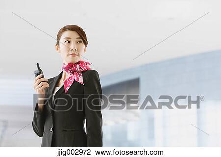 Stock Image - Japanese attractive flight attendant at the airport. Fotosearch