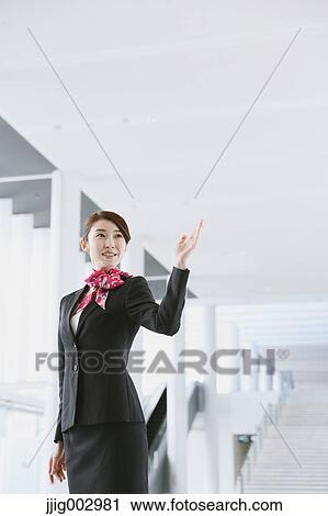 Stock Image - Japanese attractive flight attendant at the airport. Fotosearch